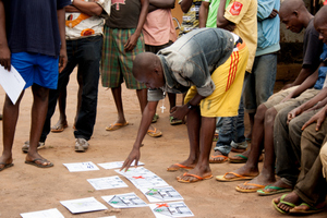 A Tswa man checks he has understood the meaning of each image correctly